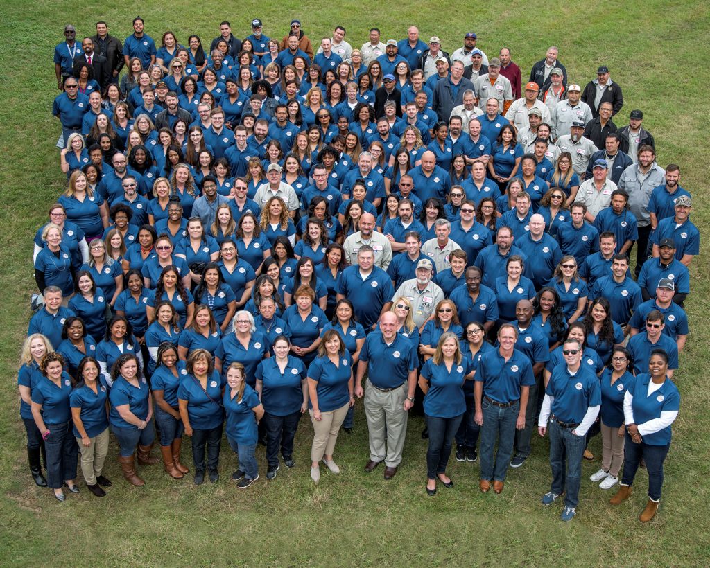 HACA Staff dressed in blue jeans and teal shirts.